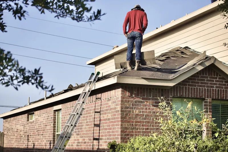 Professional roofer working on a residential roof in Gustine